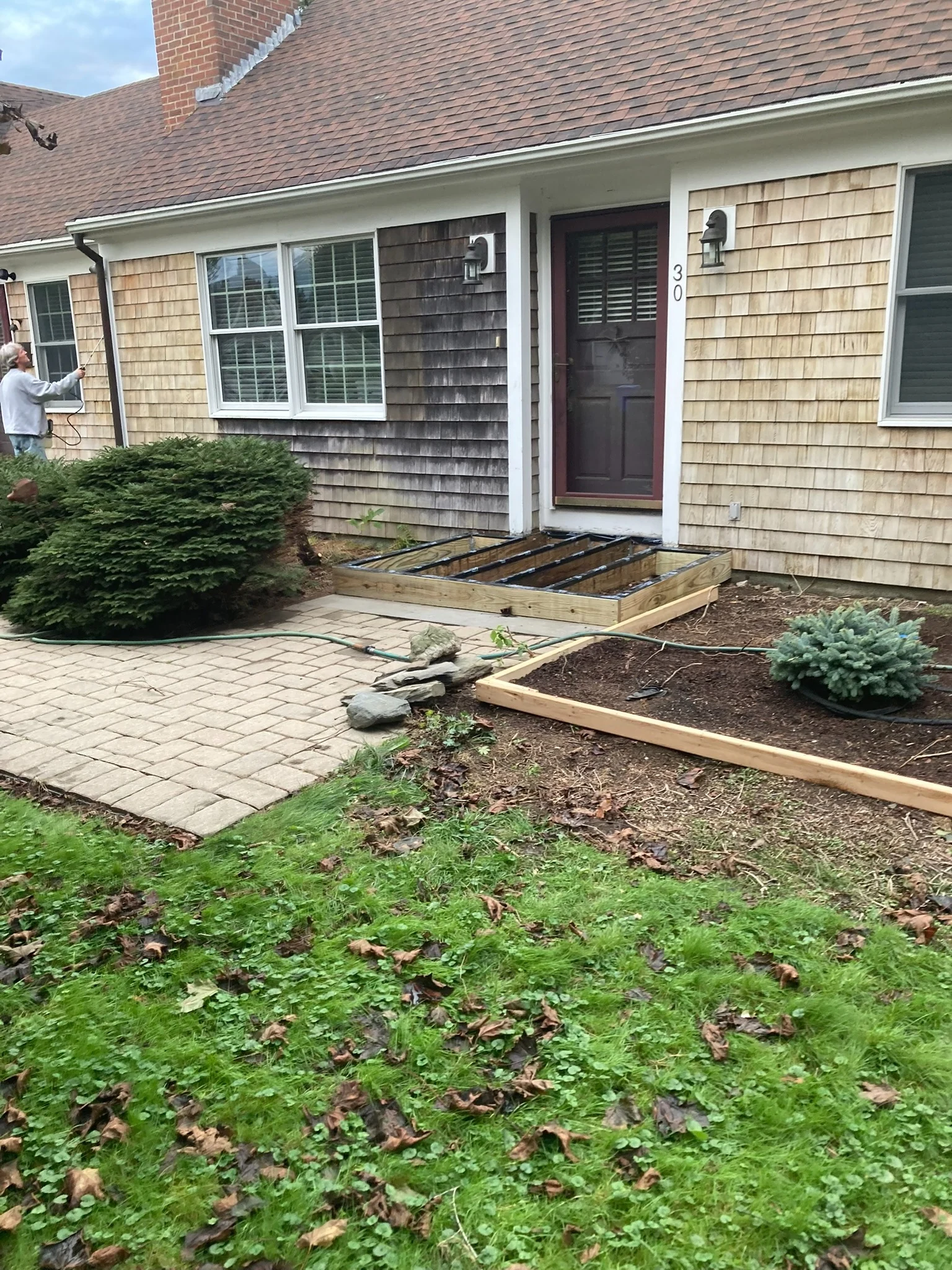 A cedar-shingle home during a professional cleaning project