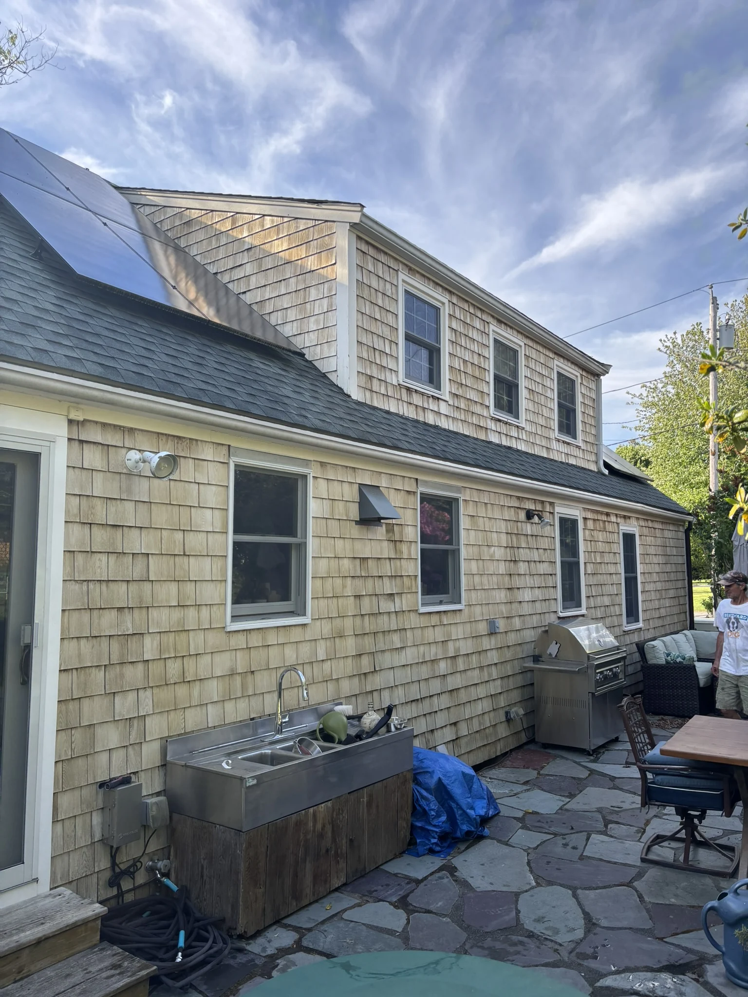 A full elevation of a cedar-shingle home with refreshed siding